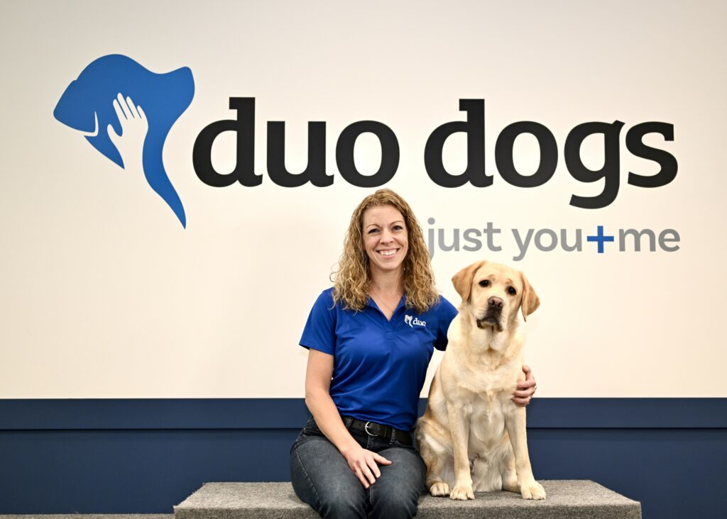 Beth sitting next to Duo Dog Woody