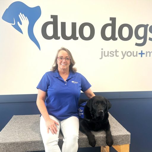 Crissy sitting next to Duo Dog Evie