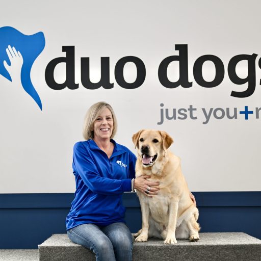 Laura sitting with Duo Dog Elliot