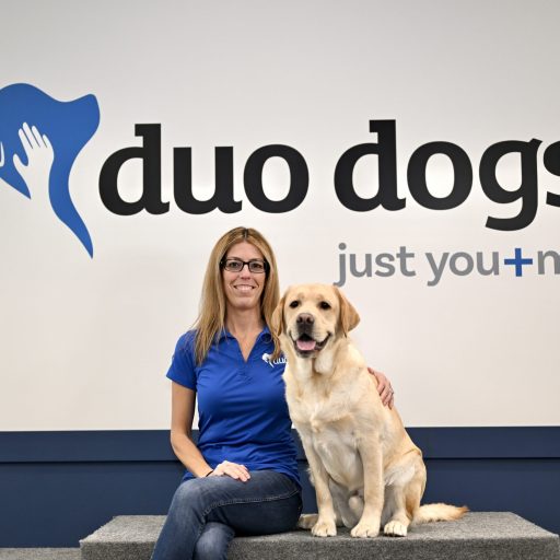 Tracy sitting with Duo Dog Woody